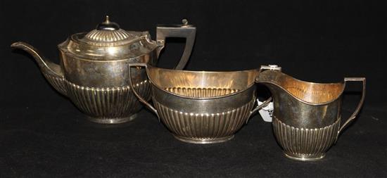 An early 20th century matched three piece silver tea set, gross 20 oz.